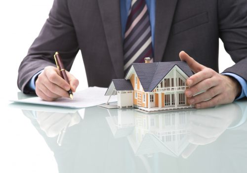 Man signs purchase agreement for a  house